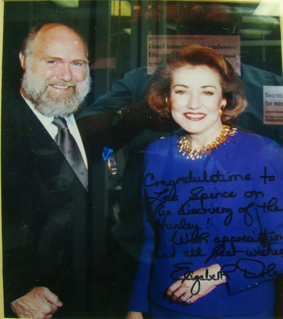Photo of Dr. E. Lee Spence with Elizabeth Dole during her bid for the presidential nomination. She has inscribed the photo "Congratulations to Lee Spence on his discovery of the Hunley!"