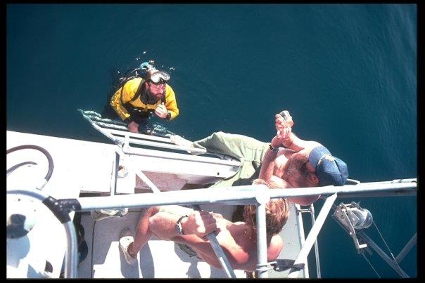 Dr. Spence on dive ladder of salvage boat.