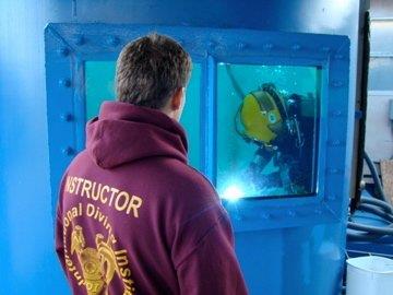 IDI Instructor monitoring student practicing underwater welding 