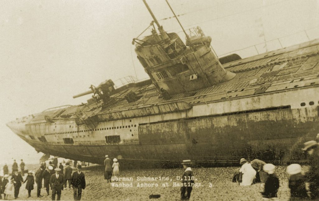 German submarine U-118 on the beach at Hastings with tourists walking around the wreck